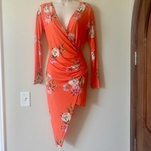 Cute asymmetrical floral summer dress with low cut neckline.New with tags. Sz 10